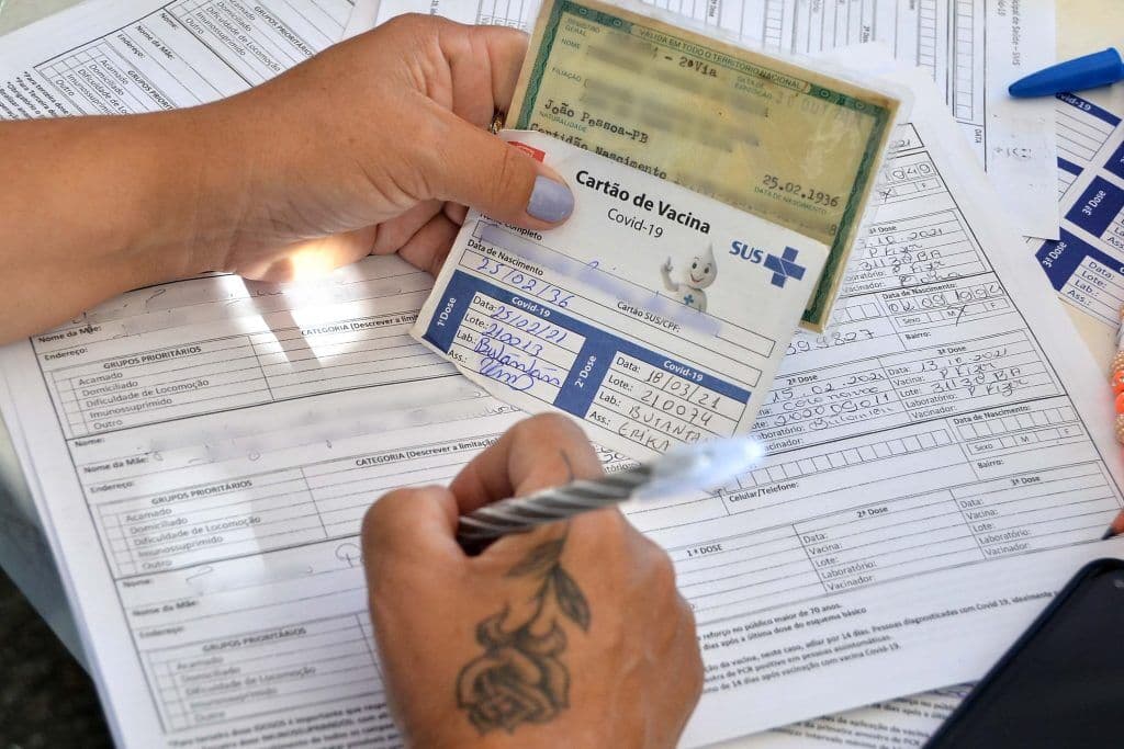 Profissionais de saúde orientam sobre a importância de completar o esquema vacinal contra Covid-19